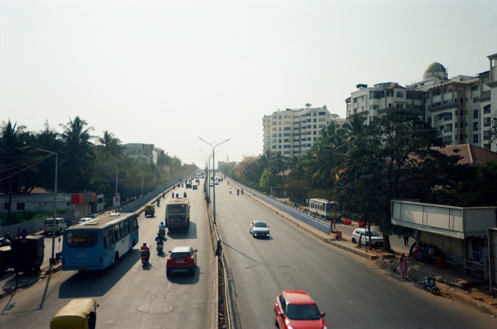 Wide Bengaluru road with buses, cars and two-wheelers